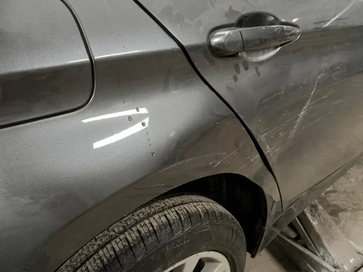 Wide view of the Kairos Auto Center repair bays with vehicles under service