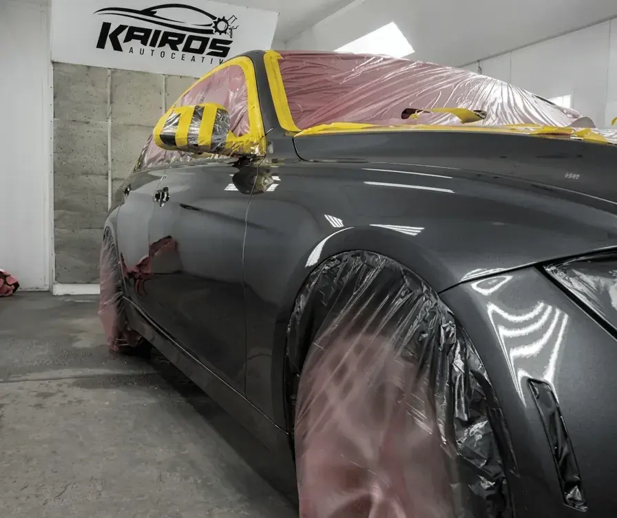 Freshly painted car panel inside the Kairos Auto Center paint booth in Worcester, MA