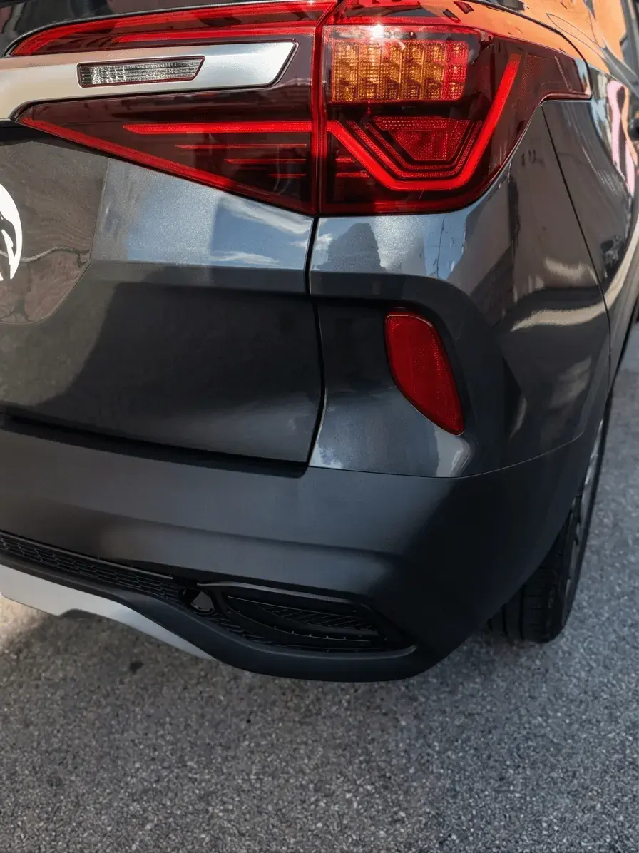 Same rear bumper and tail light restored to factory finish after repair at Kairos Auto Center